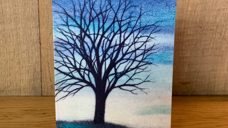 Greetings card showing a needle felted picture called 'Blue Tree at Dusk' by Annie Brown