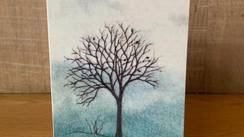 Greetings card showing a needle felted picture called 'Orchard in Winter' by Annie Brown