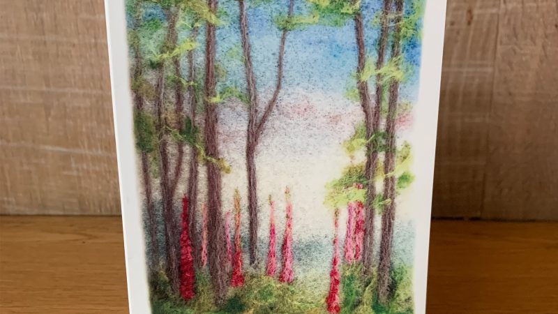 Greetings card showing needle felted foxgloves in a wood by Annie Brown